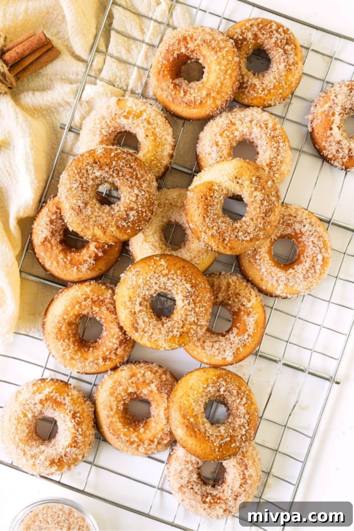 Top down view of gluten-free cider donuts on wire rack