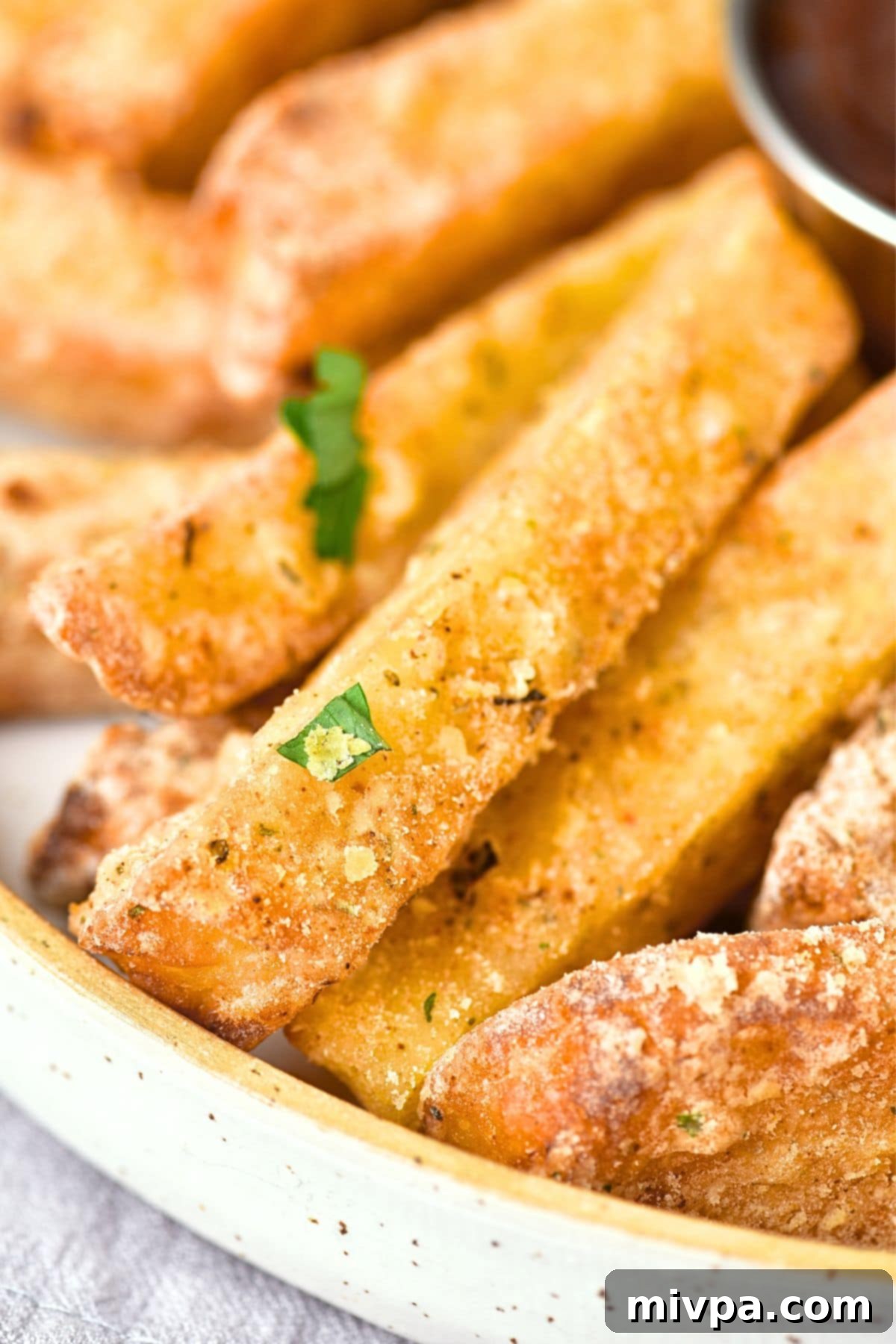 A close-up view of the textured, golden-brown surface of an air-fried halloumi fry, showing its crispiness.