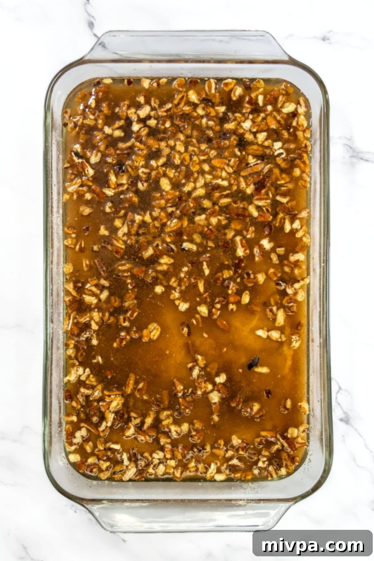 Pecans and water over cobbler batter.