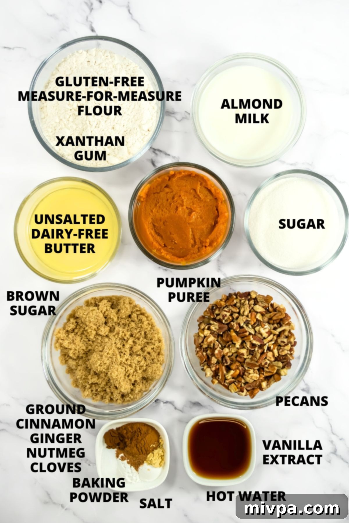 Ingredients for pumpkin cobbler recipe laid out on marble board.