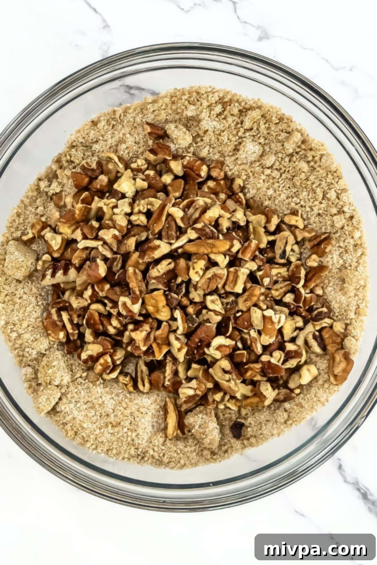 A bowl with chopped pecans and sugar