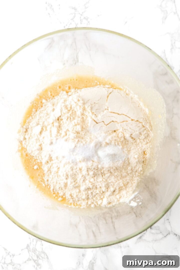 Flour mixture on top of pale yellow batter