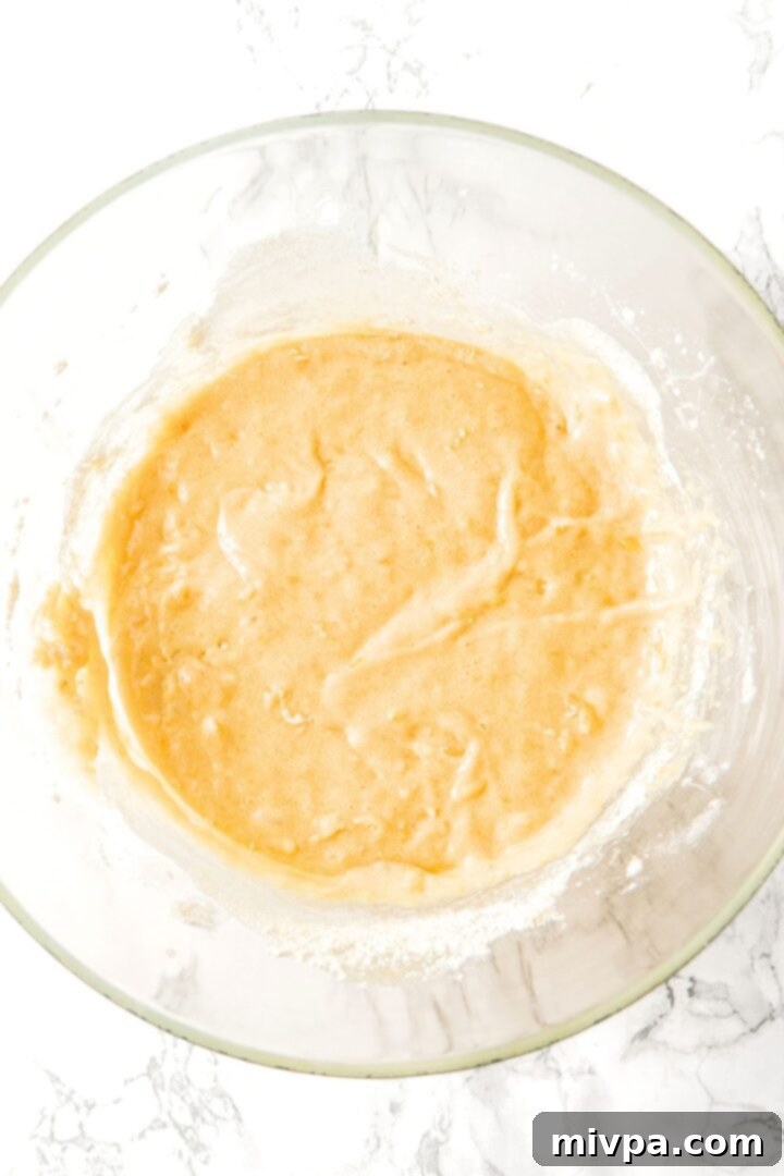 Banana bread batter in glass bowl