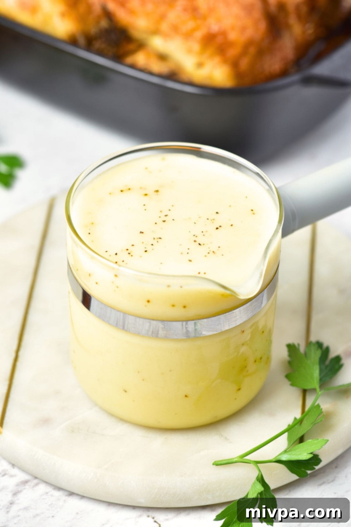 A glass jar with chicken gravy