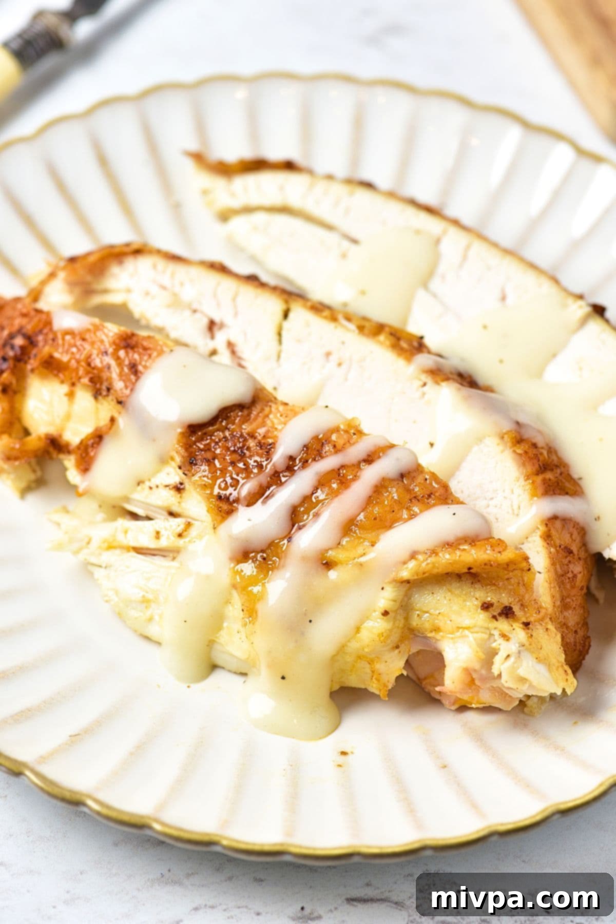 Slices of chicken breast drizzled in homemade chicken gravy