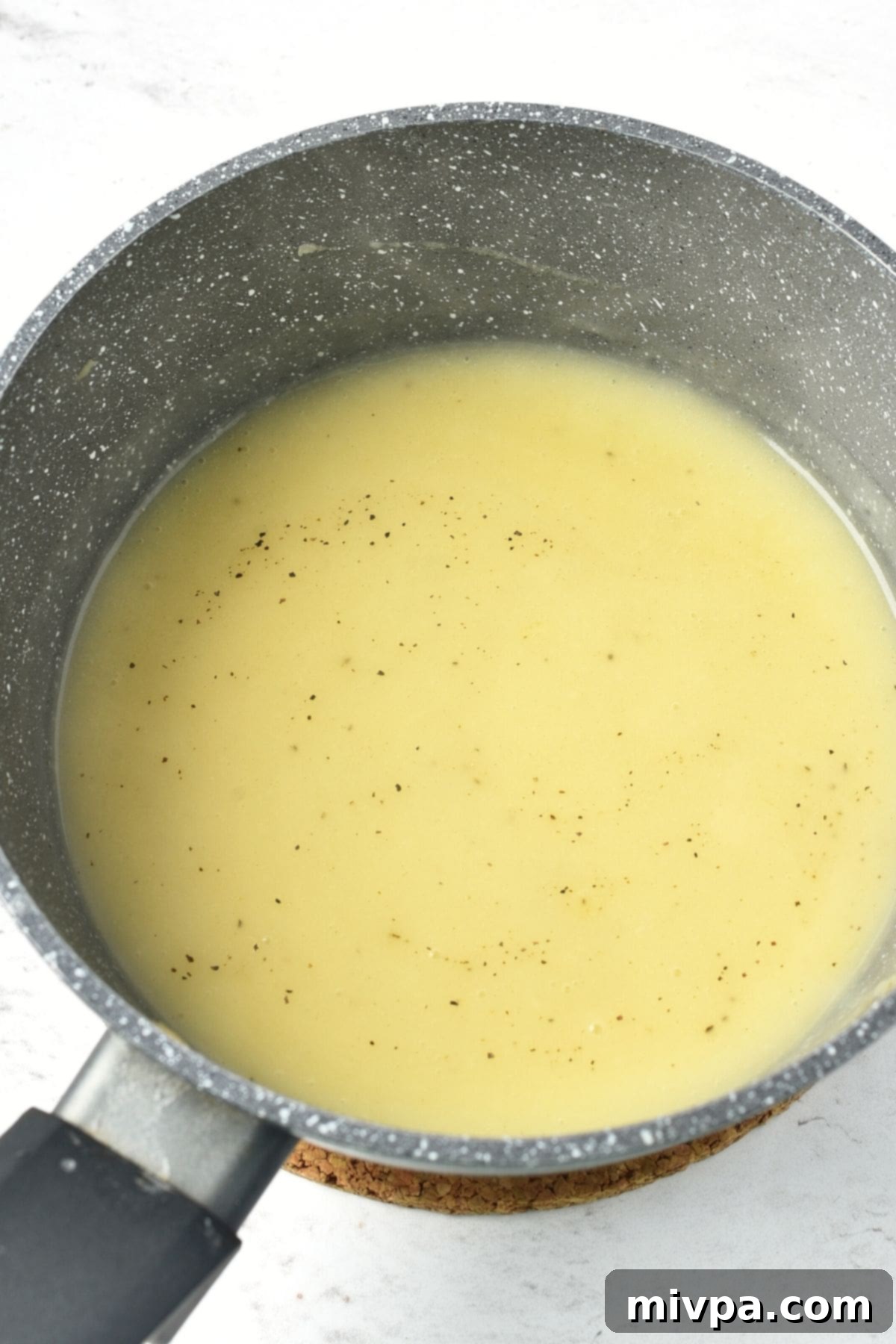 Homemade chicken gravy in saucepan