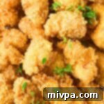 Deliciously Crispy Gluten and Dairy-Free Chicken Nuggets 4 Up close view of golden-brown gluten-free chicken nuggets, showcasing their crispy texture.