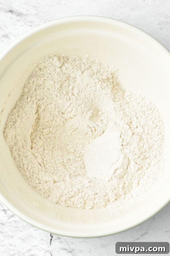 Gluten-Free Chicken Nuggets (Dairy-Free) A bowl filled with the prepared gluten-free flour and spice mixture, ready for coating chicken.