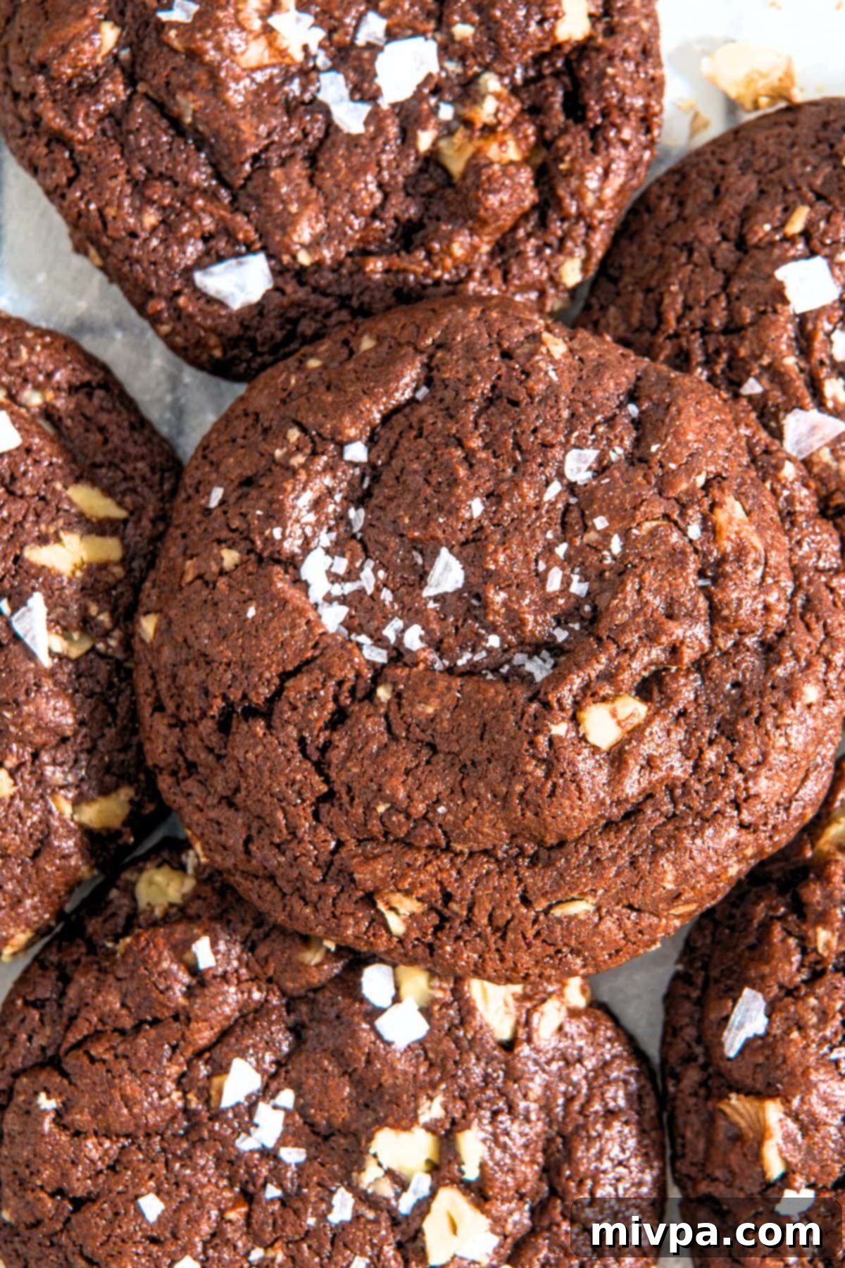 Gluten-Free Dairy-Free Chocolate Walnut Cookies Top-down view of fudgy gluten-free chocolate walnut cookies, lightly sprinkled with flaky sea salt.