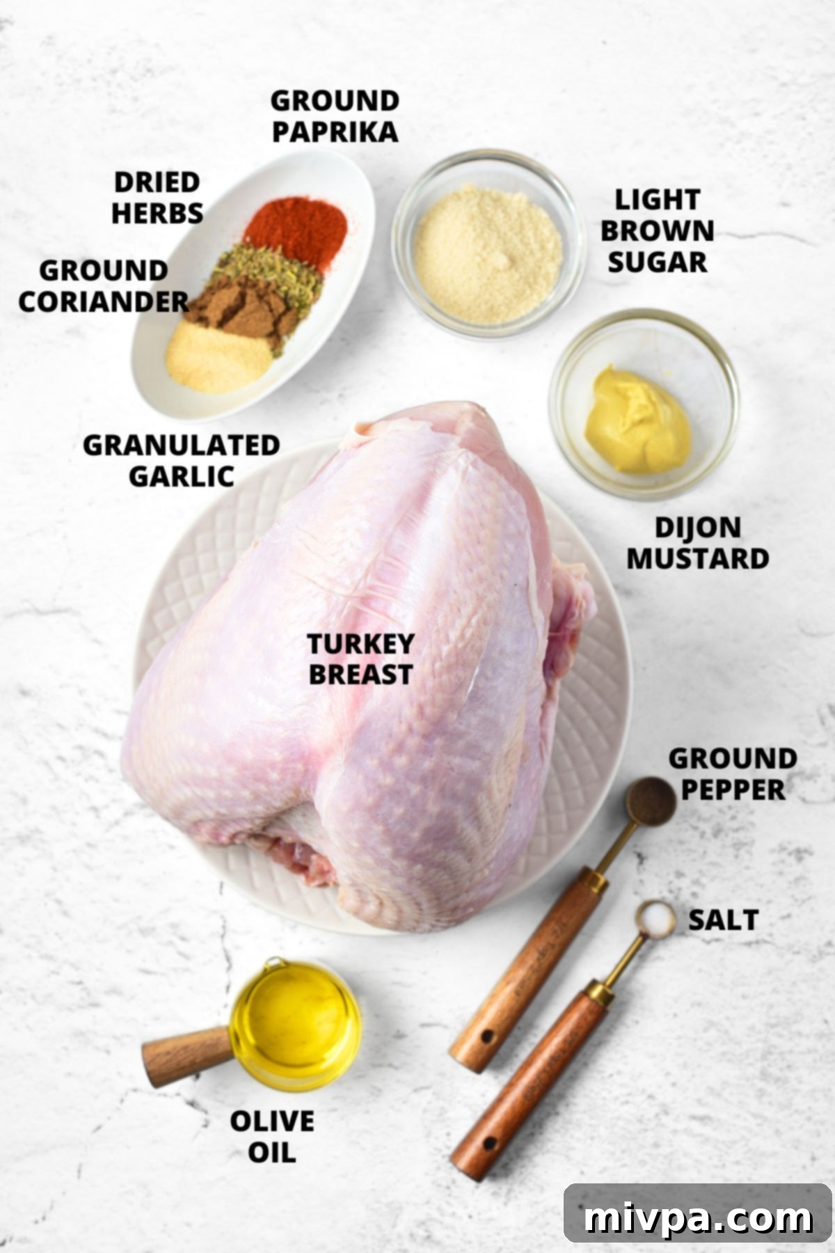 Top down view of ingredients required for roasted turkey breast recipe laid out on marble board.