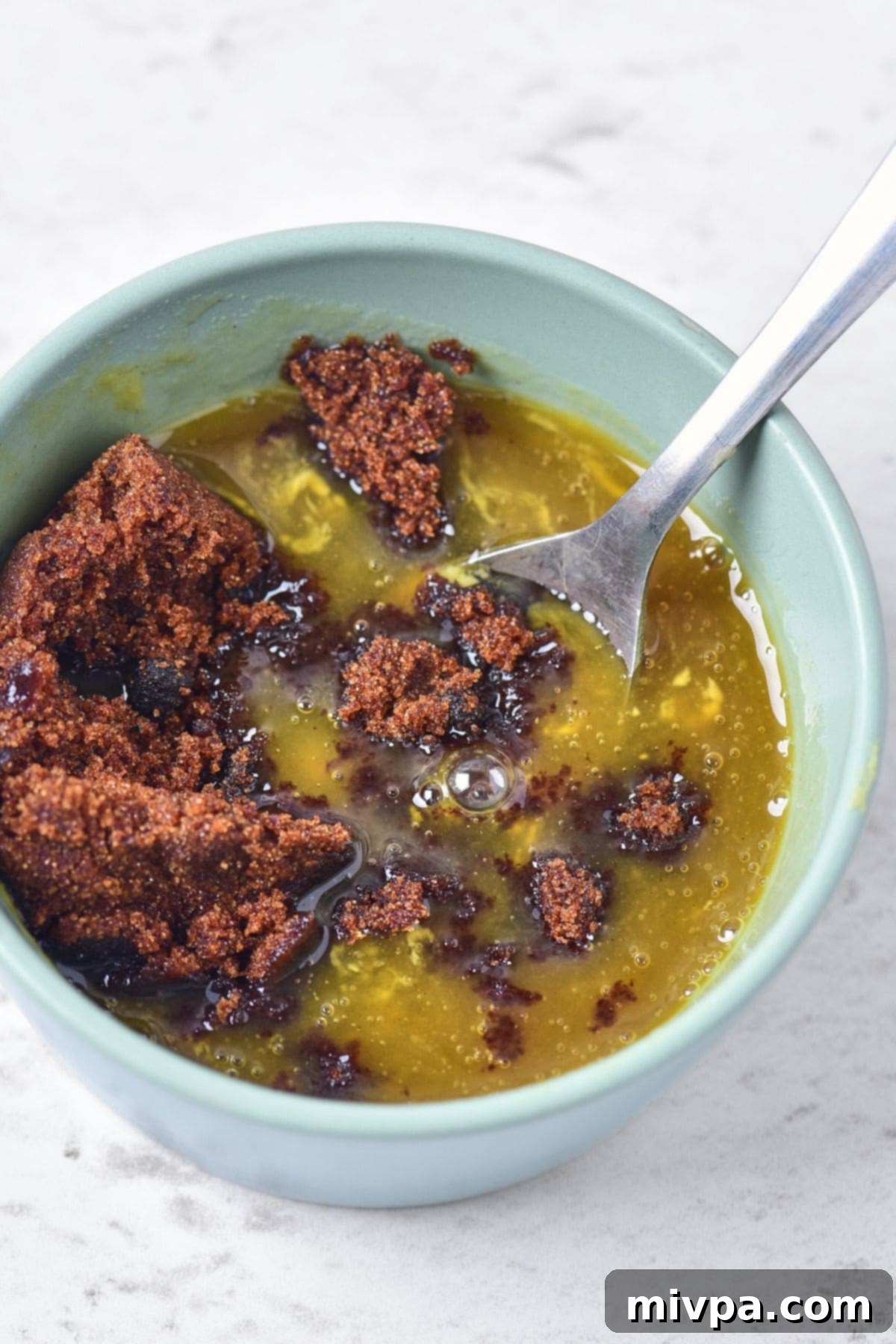 Mixing brown sugar, honey and mustard in bowl
