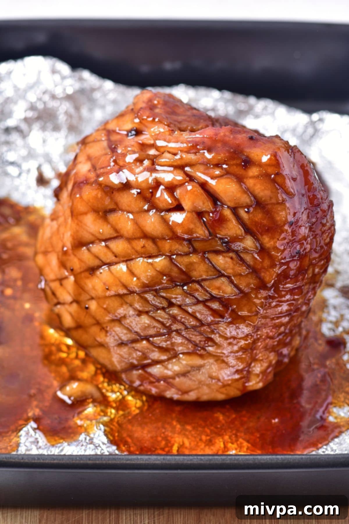 Glazed honey ham on aluminum foil