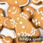 Easy Gluten-Free Dairy-Free Gingerbread Men 3 Up close shot of exquisitely decorated gluten-free gingerbread men cookies, showcasing their holiday charm.