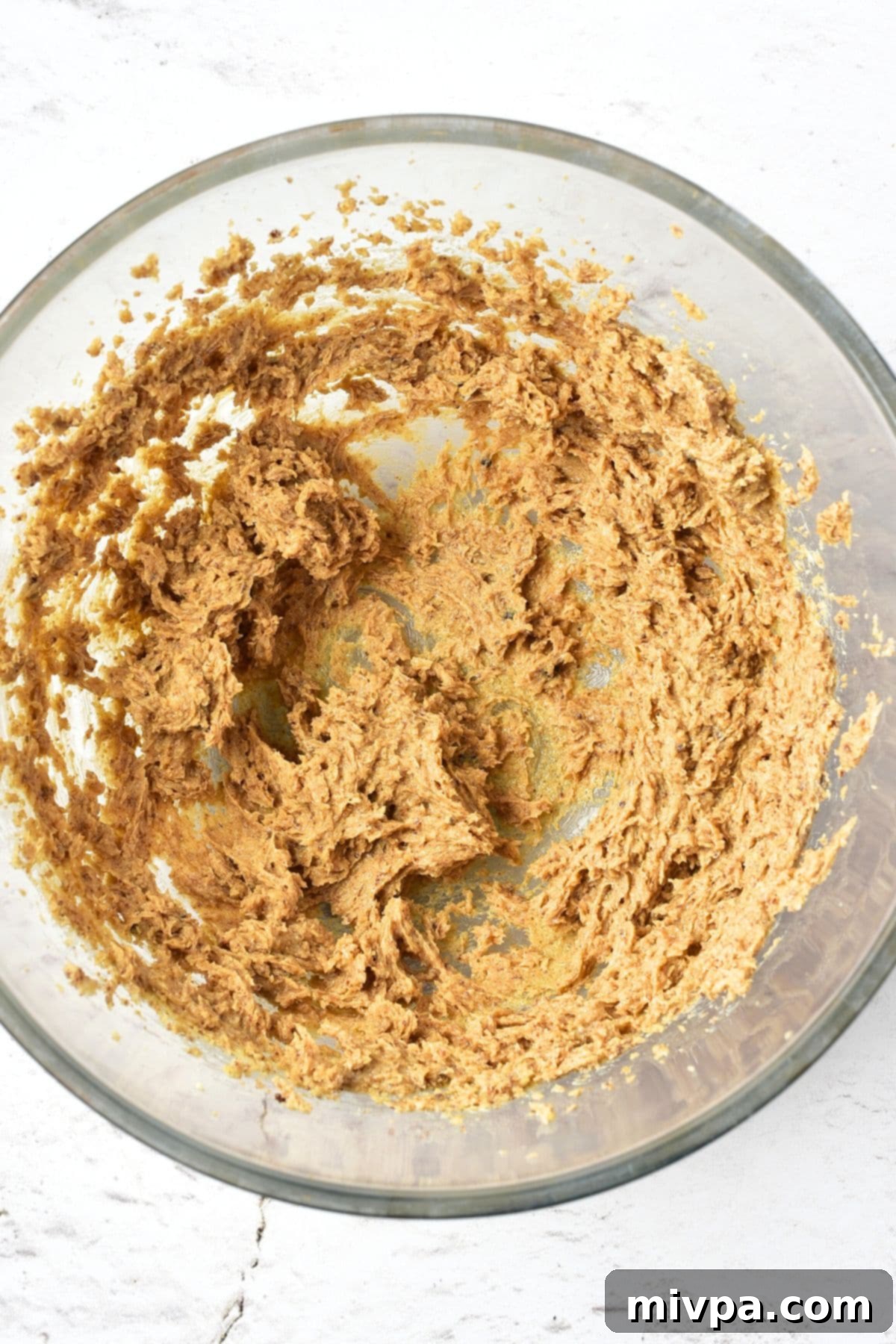 Gluten-Free Dairy-Free Gingerbread Men Cookies Creamy brown butter-sugar mixture in a glass mixing bowl, perfectly blended and light.