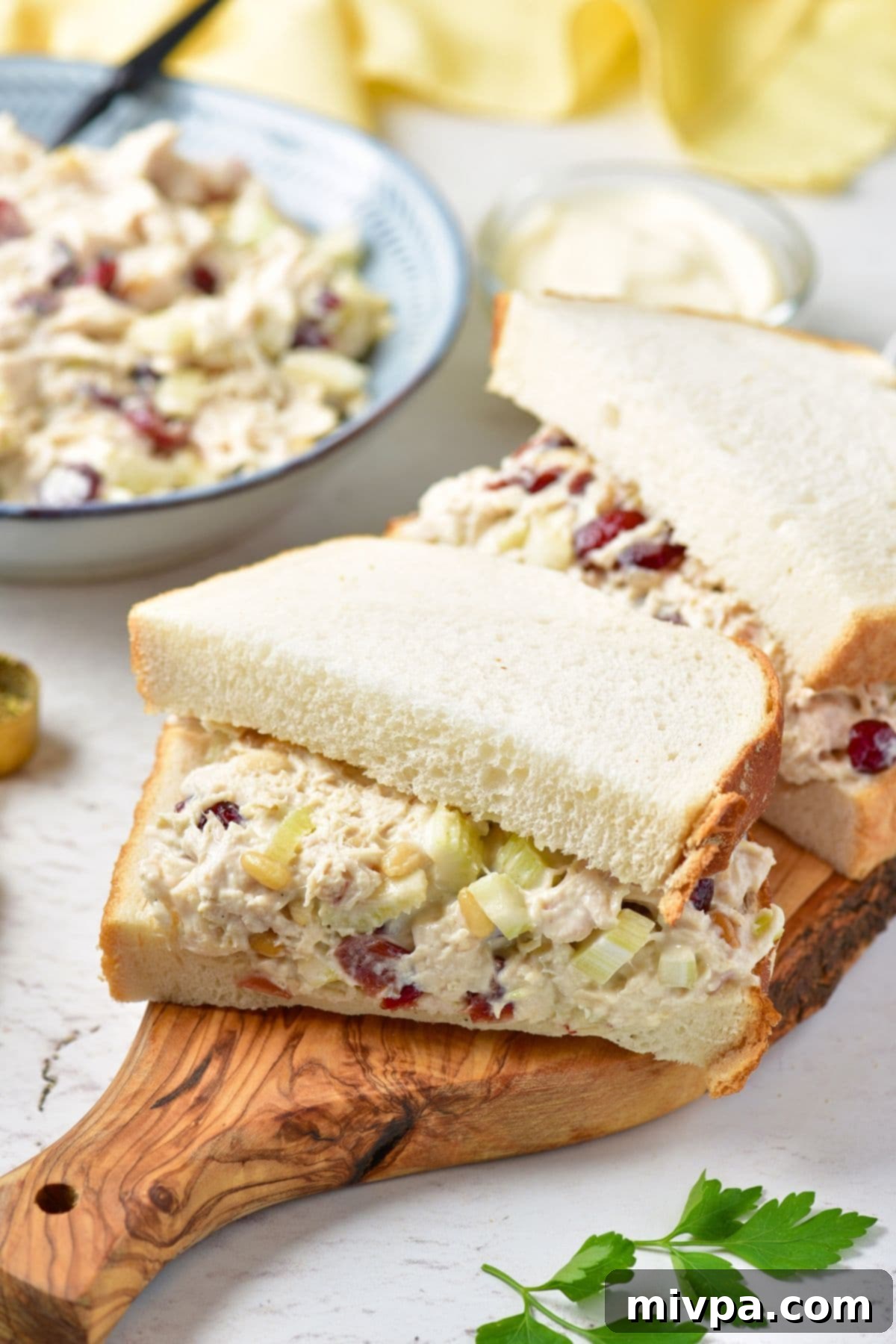 Cranberry Chicken Salad Sandwiches (Gluten-Free, Dairy-Free) Chicken cranberry salad sandwiches on a rustic wooden board, ready for a delightful lunch.