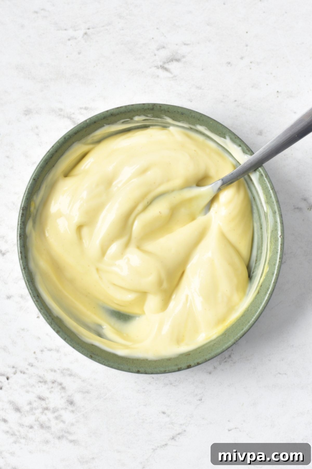Gluten-Free Dairy-Free Chicken Salad with Dried Cranberries A bowl of creamy salad dressing, made from mayonnaise and mustard.