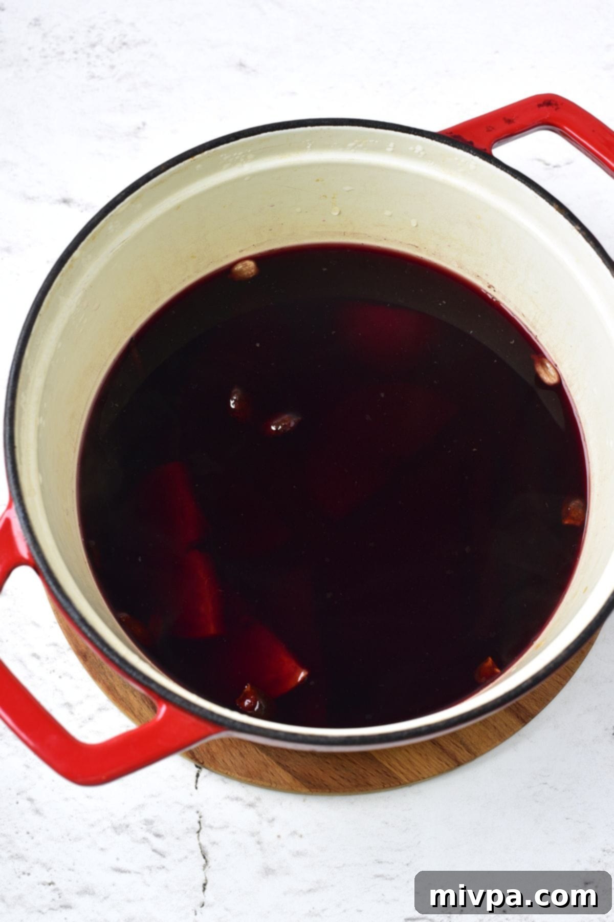 Simple Homemade Mulled Wine Gluten-Free and Vegan 7 Step 2: Mulled wine ingredients are gently simmering in a saucepan on a stovetop.