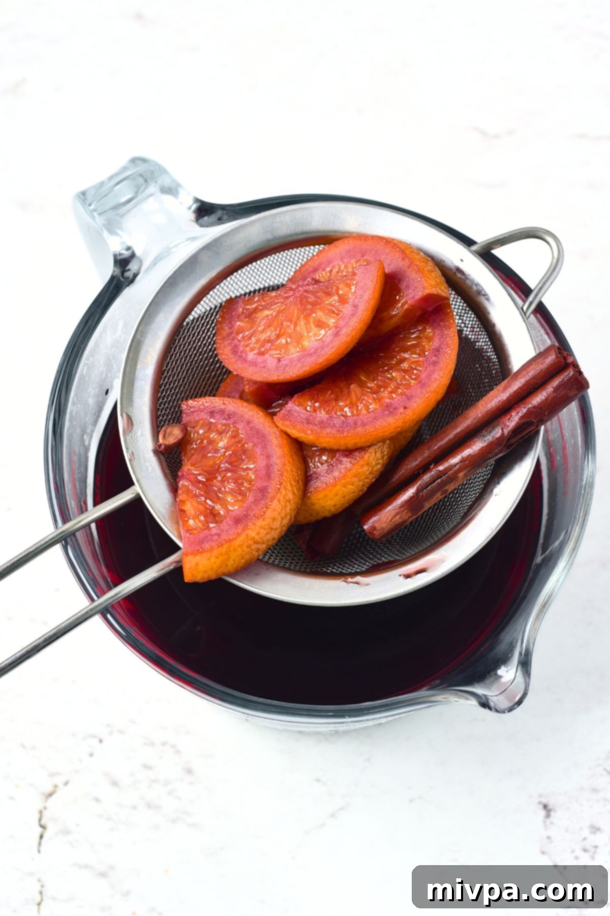 Simple Homemade Mulled Wine Gluten-Free and Vegan 8 Step 3: Mulled wine is steeping in a saucepan, covered with a lid, allowing flavors to infuse.