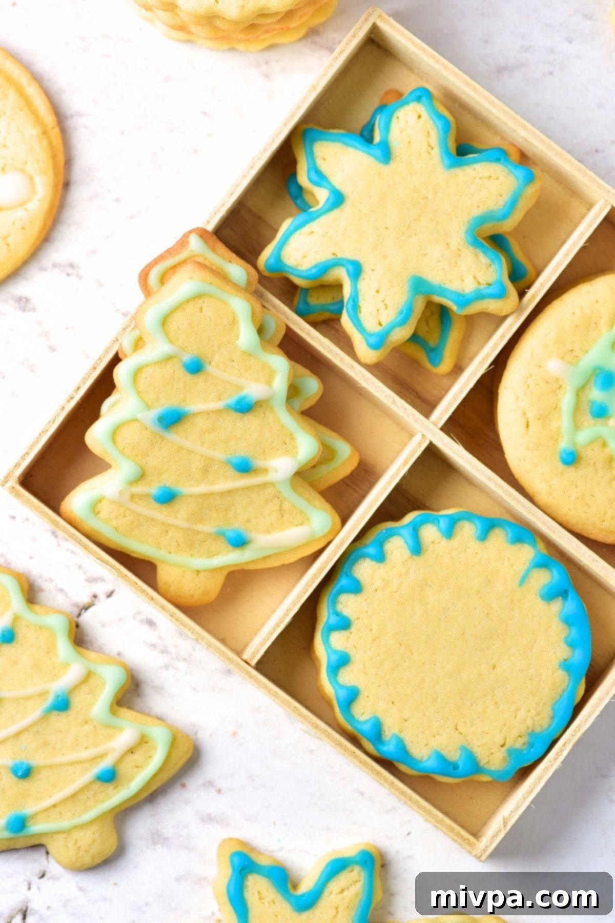 How to Make Christmas Sugar Cookies Up close view of a festive box filled with various decorated Christmas sugar cookies, ready for sharing or gifting.