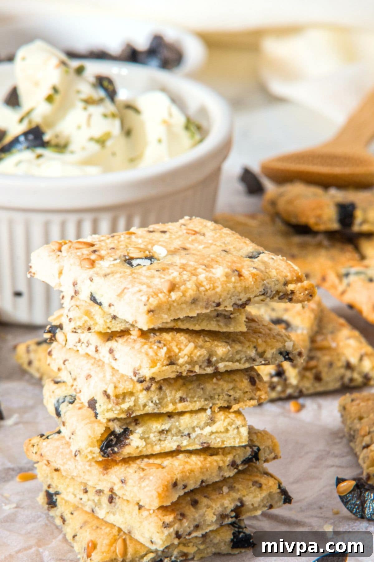 Gluten Dairy-Free Almond Flour Crackers A stack of almond flour cheese crackers on parchment