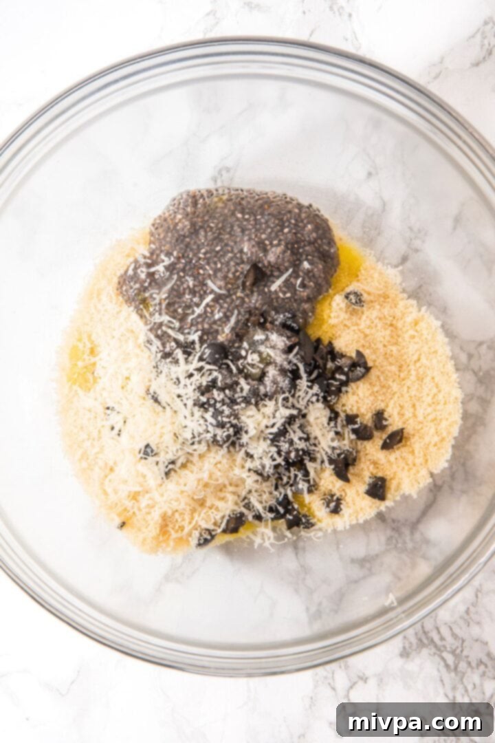 Almond Flour Crackers (Gluten-Free, Dairy-Free) Chia seed mixture, shredded cheese, chopped olives, and olive oil in bowl