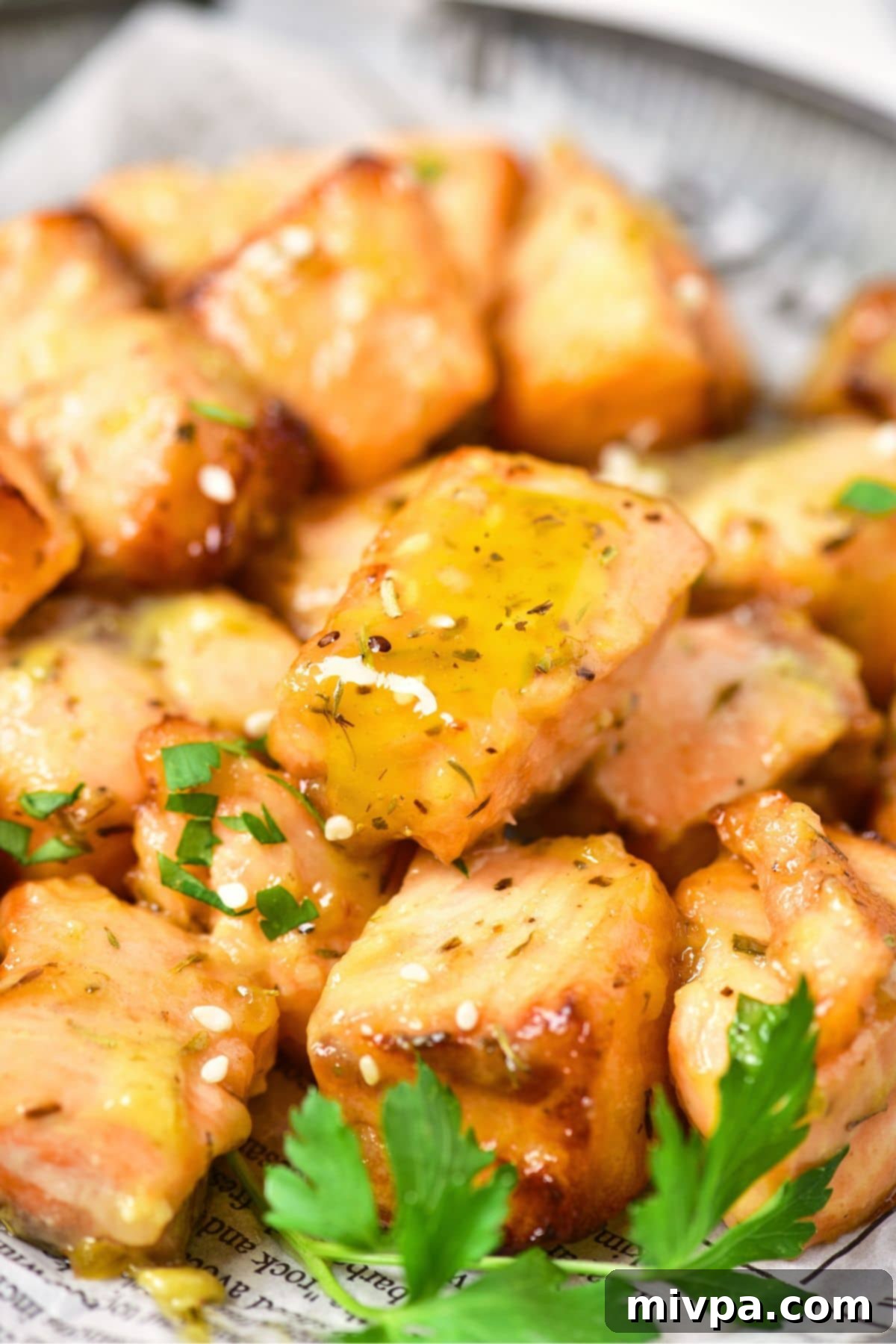 Up close view of pieces of air fried salmon with honey mustard