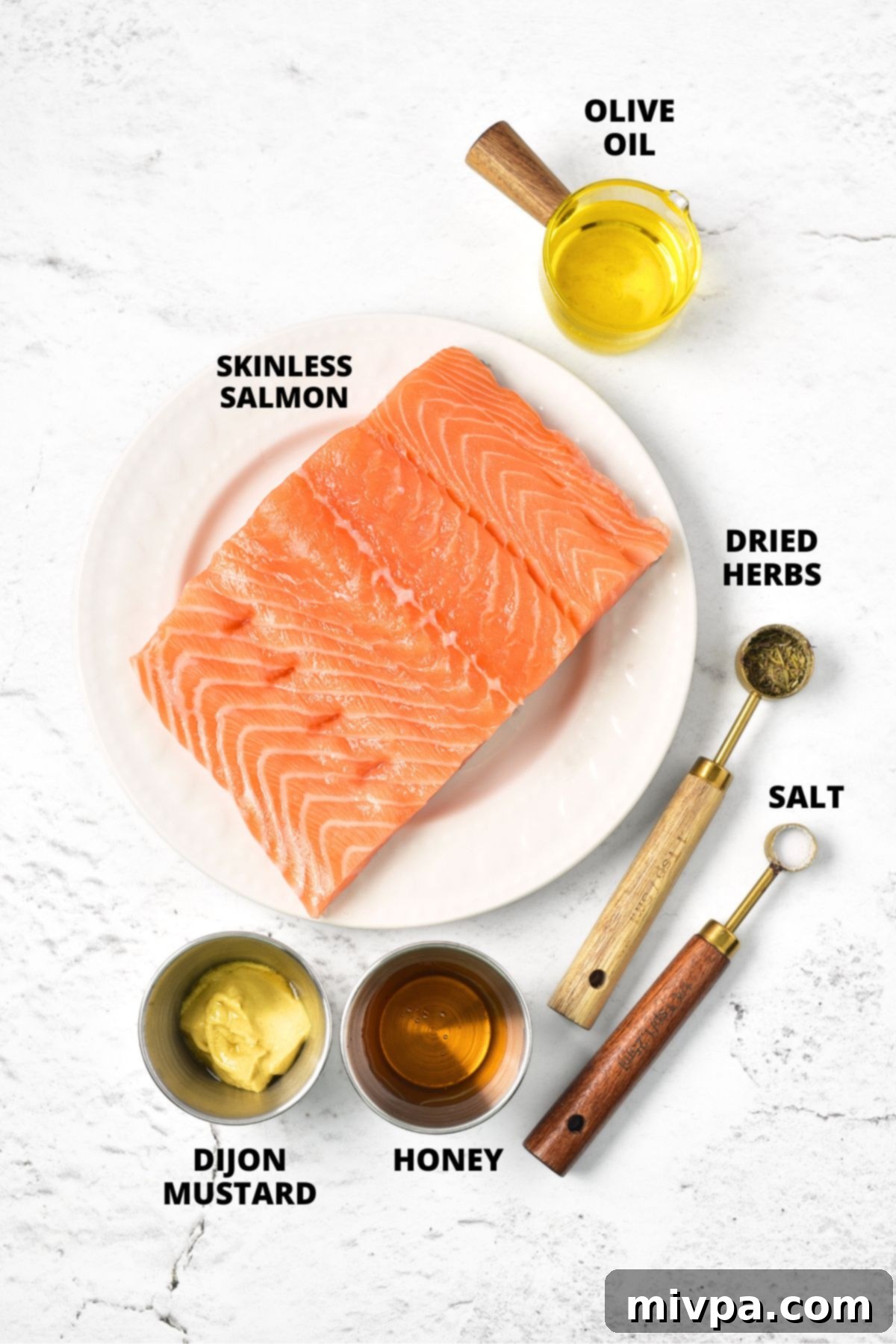 Ingredients for air fryer salmon bites recipe laid out on marble board.