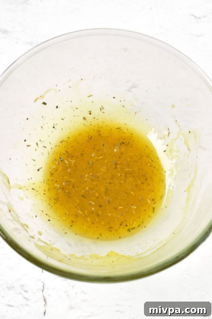 Honey mustard marinade in glass mixing bowl