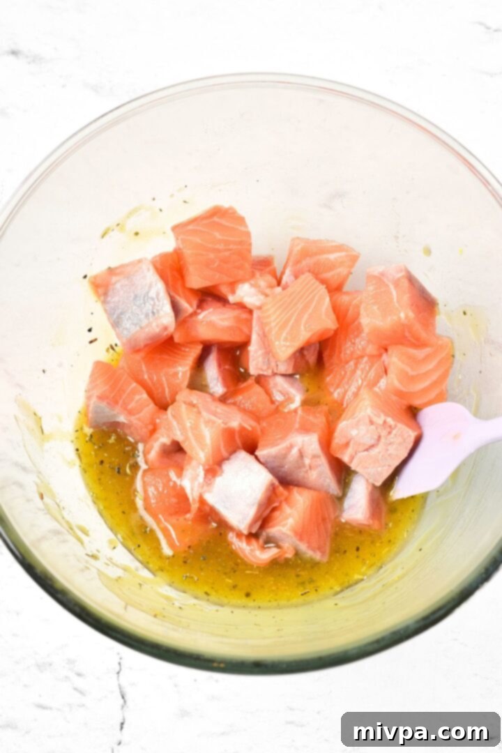 Mixing salmon cubes in marinade