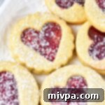 Linzer cookies sprinkled with powdered sugar