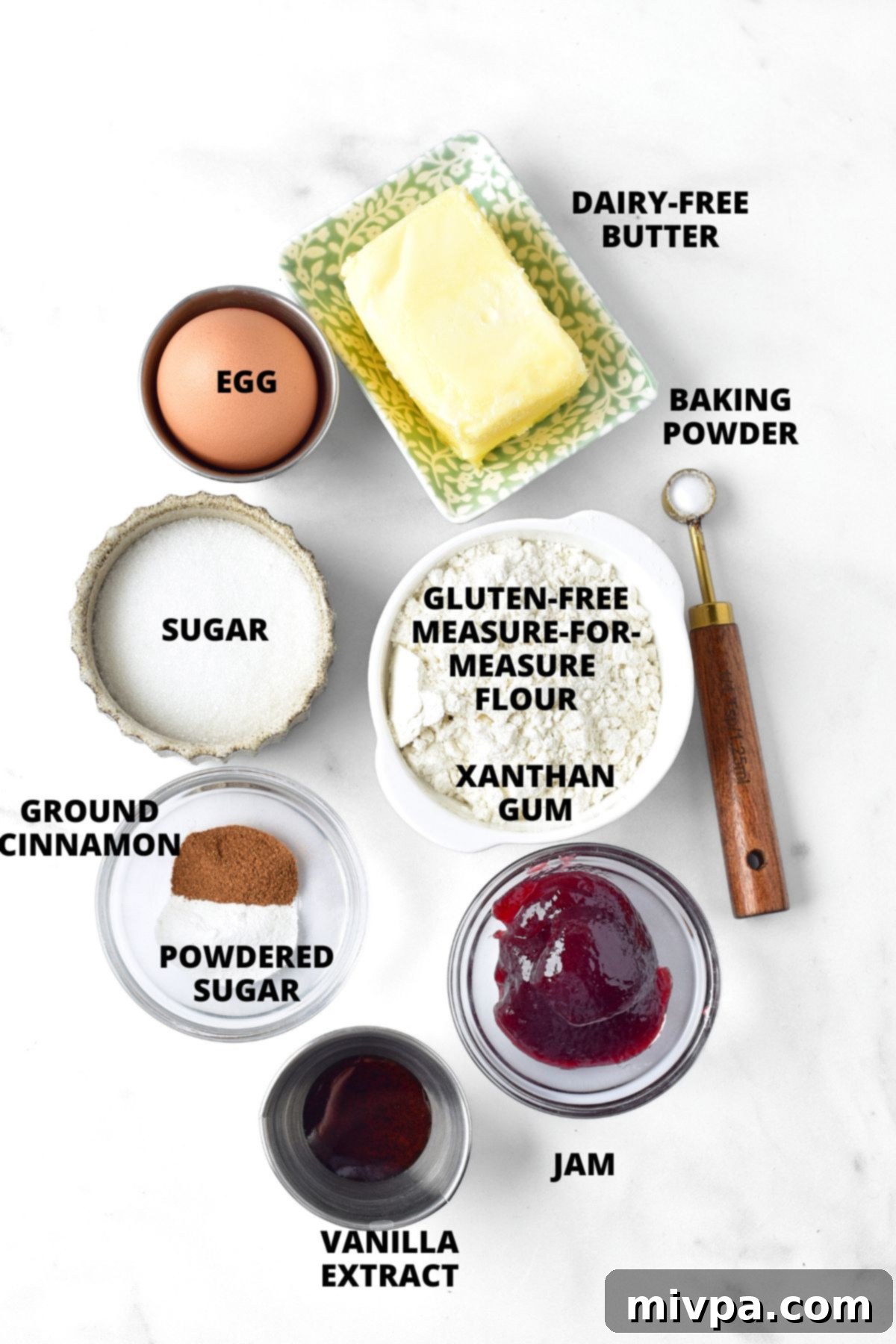 All the ingredients for gluten-free Linzer cookies recipe, neatly laid out on a marble board.