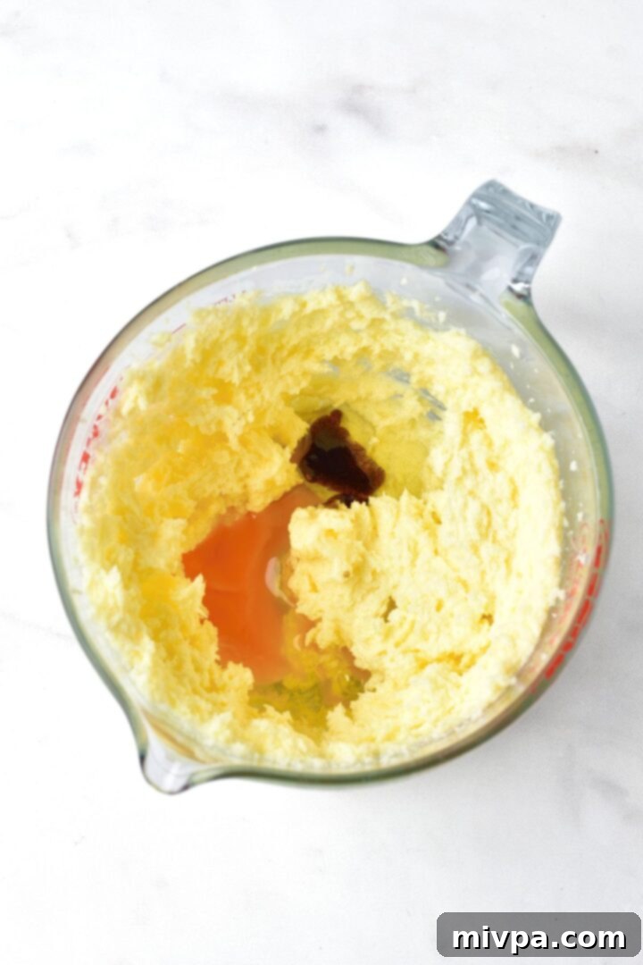 Mixing cookie dough ingredients in a bowl with an electric mixer.