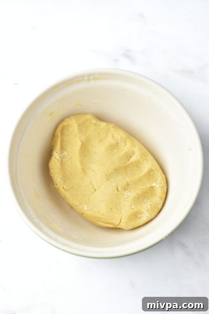 Smooth cookie dough in a white bowl, ready for chilling.