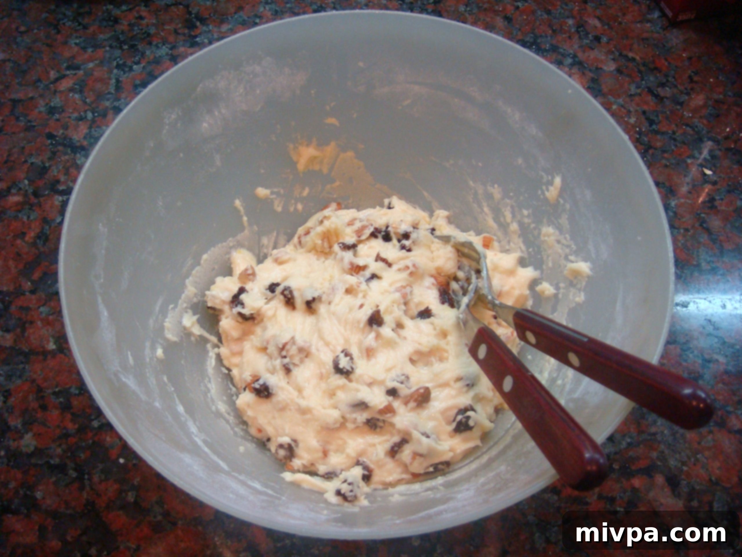 Zesty Lemon Almond Raisin Biscotti 11 The biscotti dough after the almonds and raisins have been thoroughly mixed in, showcasing a homogenous texture with inclusions evenly dispersed.
