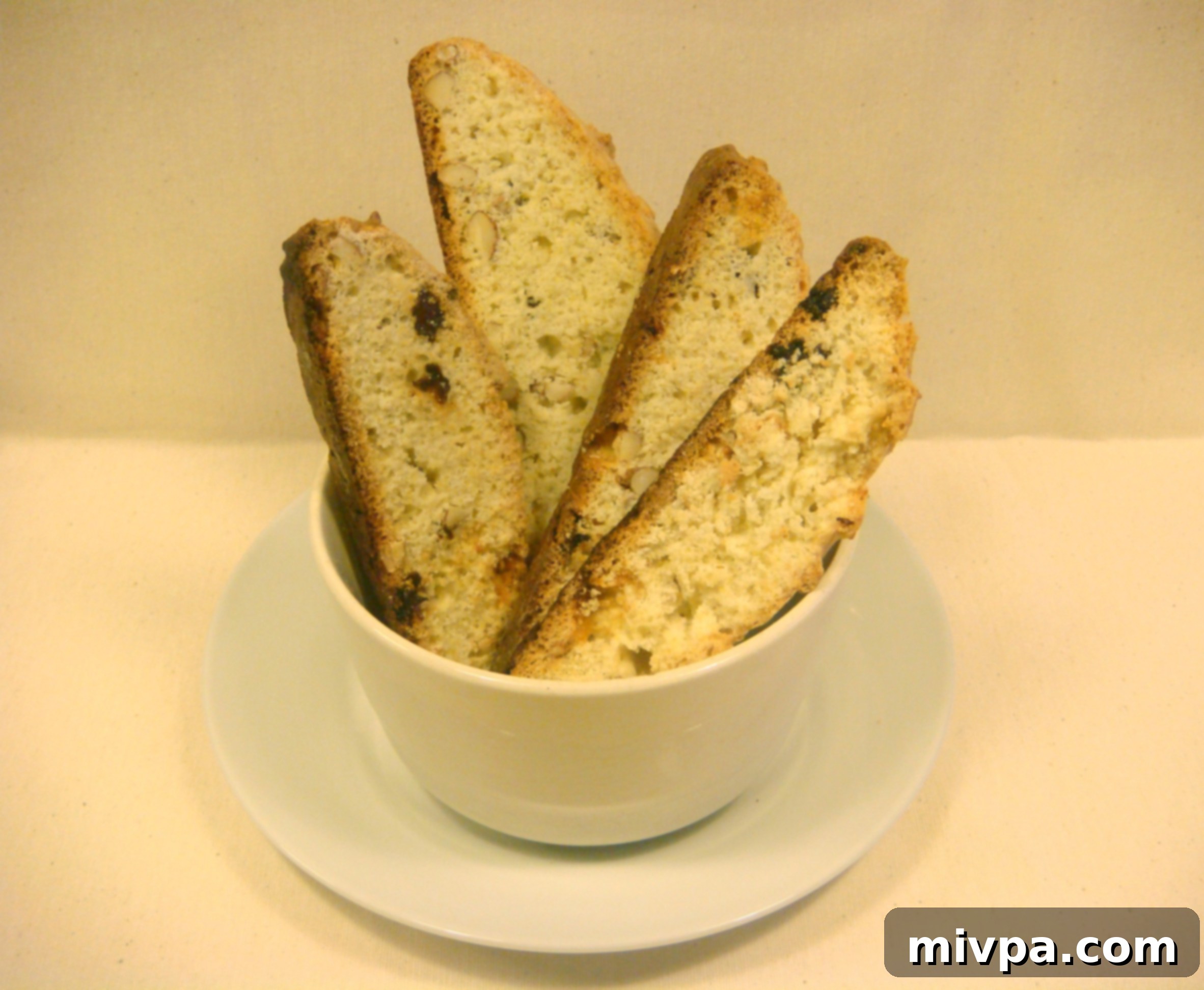 Zesty Lemon Almond Raisin Biscotti 17 A batch of golden-brown, freshly baked almond and raisin biscotti, cooling on a wire rack, signifying they are perfectly crunchy and ready to be savored.