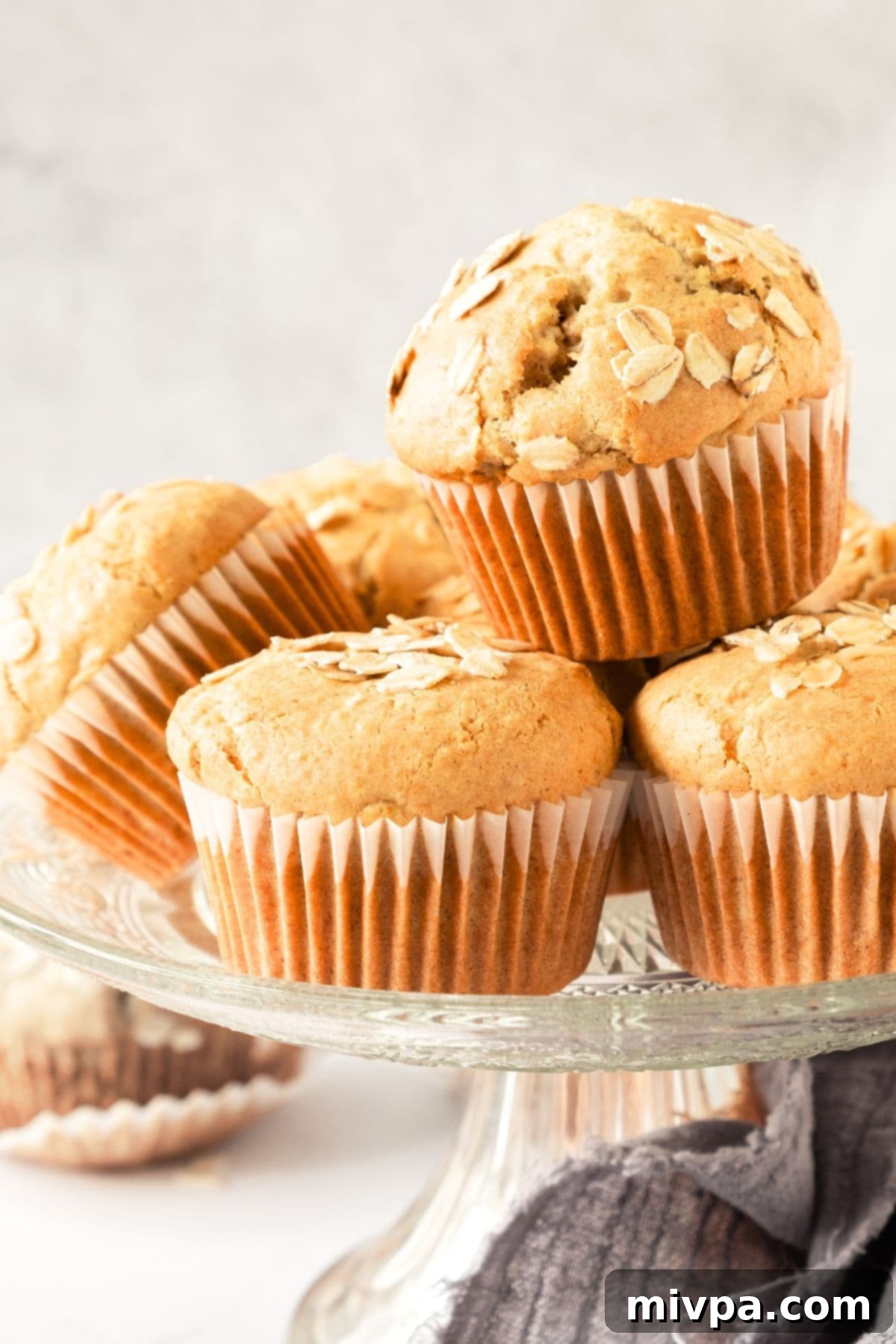 Easy Oatmeal Muffins Recipe A display of easy oatmeal muffins on a elegant cake stand, ready for serving.