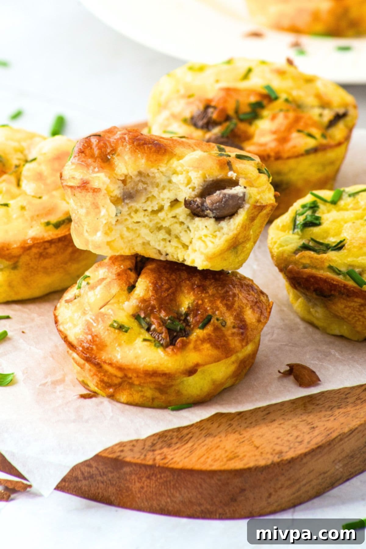 High-Protein Cottage Cheese and Egg Muffins (Gluten-Free) Up close view of half-eaten cottage cheese and egg muffins, showcasing their fluffy texture and savory fillings.