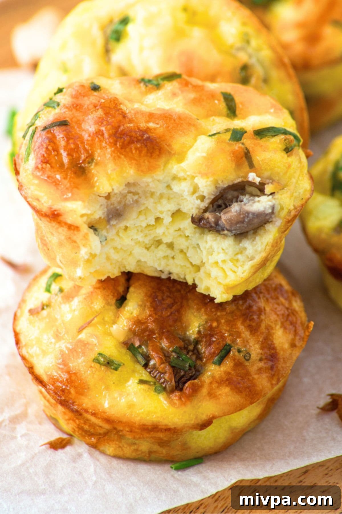 Gluten-Free Egg Muffins with Cottage Cheese A close-up of a perfectly baked, half-eaten egg muffin, revealing its rich and fluffy interior.