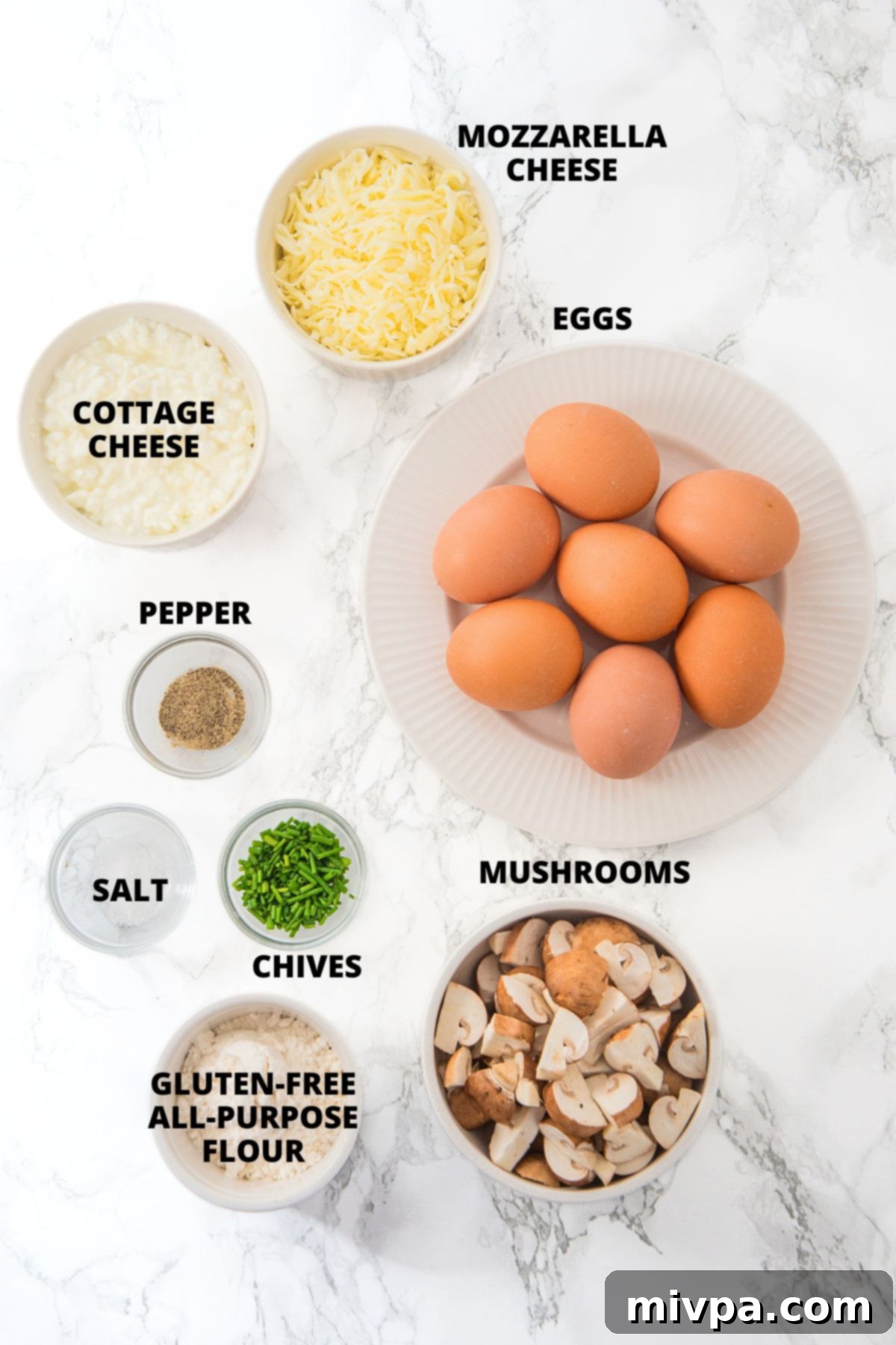 Cottage Cheese and Egg Muffins Recipe (Gluten-Free) A selection of fresh ingredients for cottage cheese and egg muffins, neatly laid out on a clean white board.
