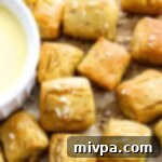 Gluten-free pretzel bites on parchment paper, beautifully golden.