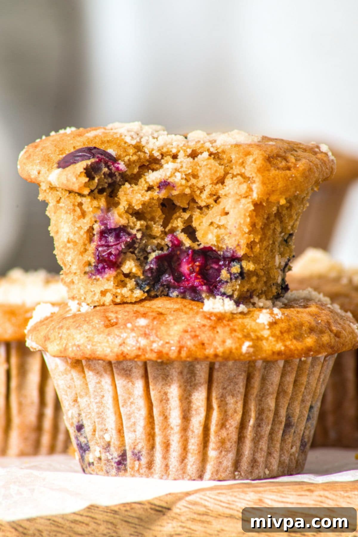 Cottage Cheese Blueberry Muffins (Gluten-Free) Half-eaten cottage cheese blueberry muffin revealing its moist interior and scattered blueberries