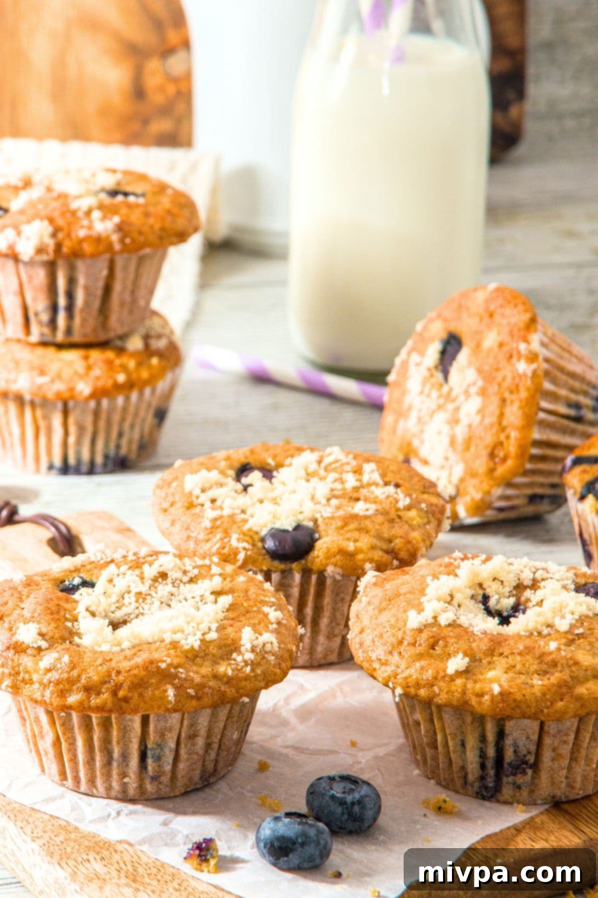 Blueberry Cottage Cheese Muffins (Gluten-Free) Freshly baked blueberry cottage cheese muffins arranged neatly on parchment paper.
