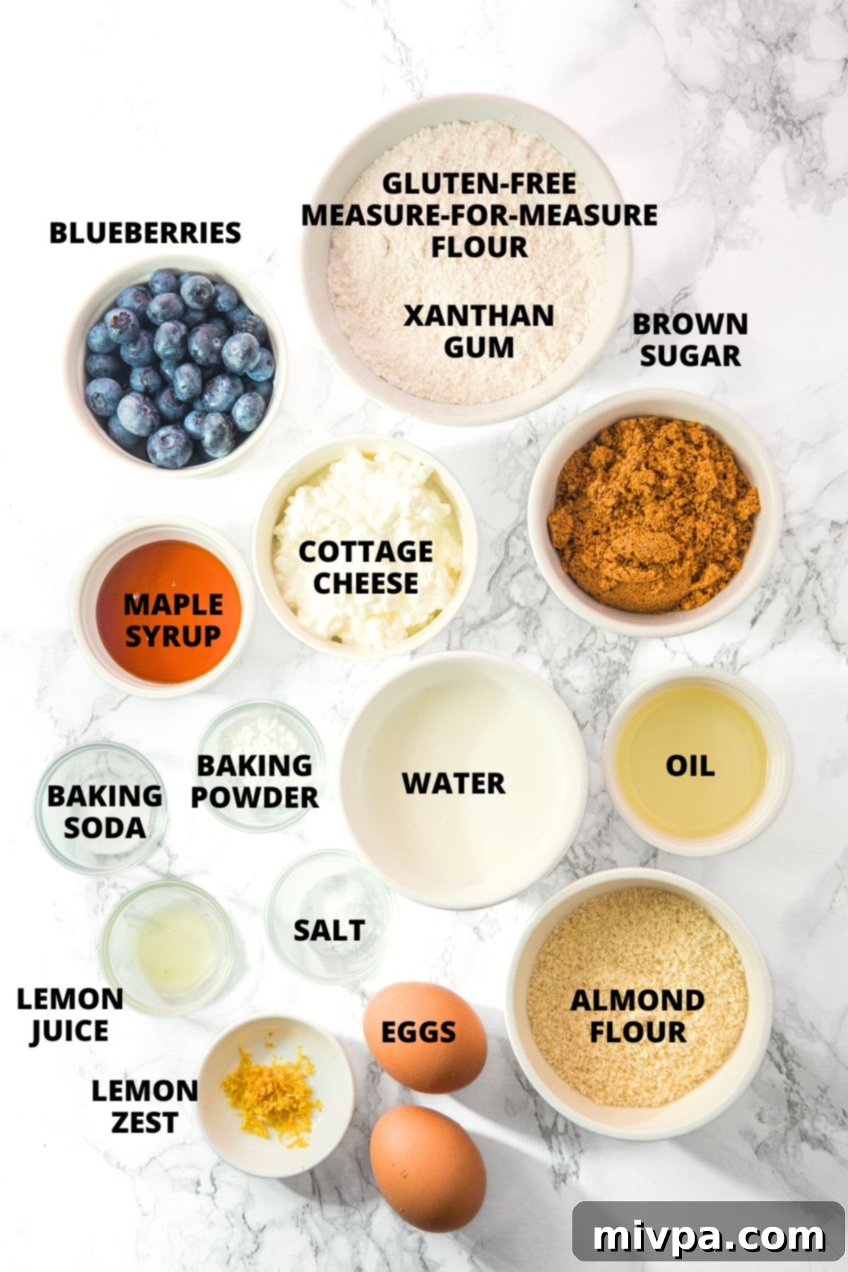 Cottage Cheese Blueberry Muffins Recipe (Gluten-Free) All ingredients for cottage cheese blueberry muffins recipe neatly laid out on a marble board, ready for baking