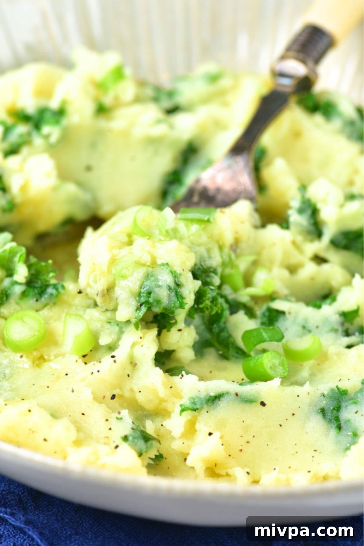 How to Make Colcannon: A Step-by-Step Guide Colcannon mashed potatoes with fresh kale and sliced green onions ready to serve