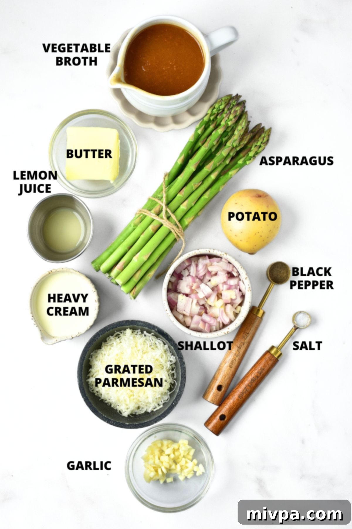 Ingredients for asparagus potato soup recipe laid out on board.