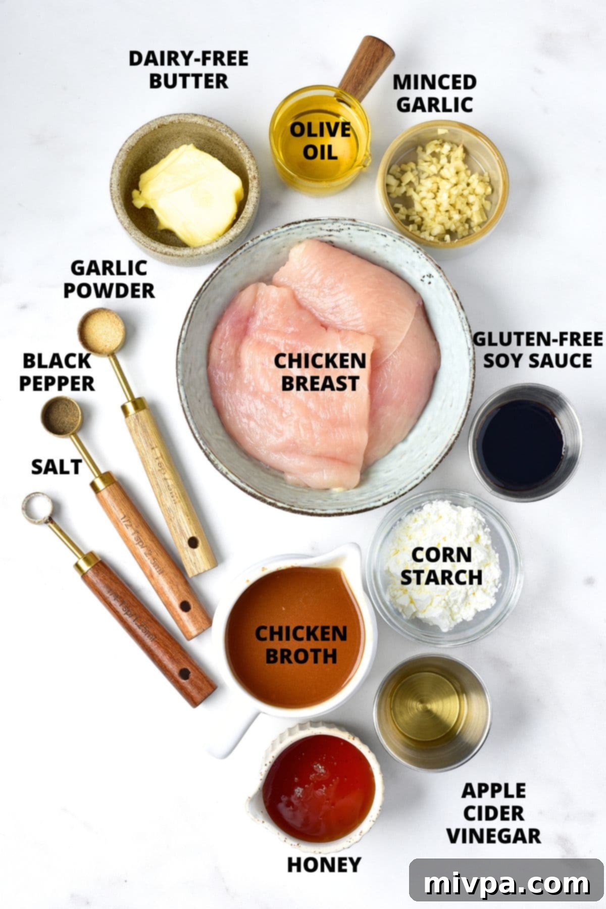 Gluten-Free Honey Garlic Chicken Recipe A flat lay of ingredients for gluten-free honey garlic chicken recipe on a marble board.