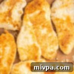 Freshly baked homemade gluten-free breaded chicken, showcasing a beautiful golden crust and tender interior.