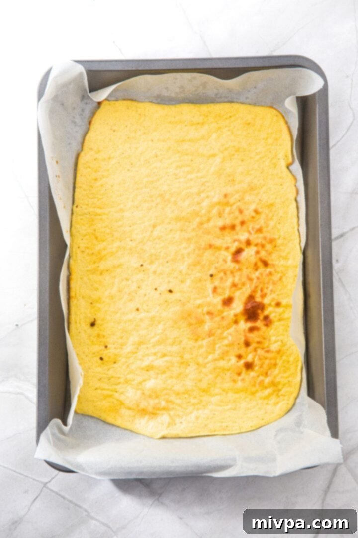 Cottage Cheese Egg Flatbread Freshly baked cottage cheese egg flatbread in parchment-lined pan.