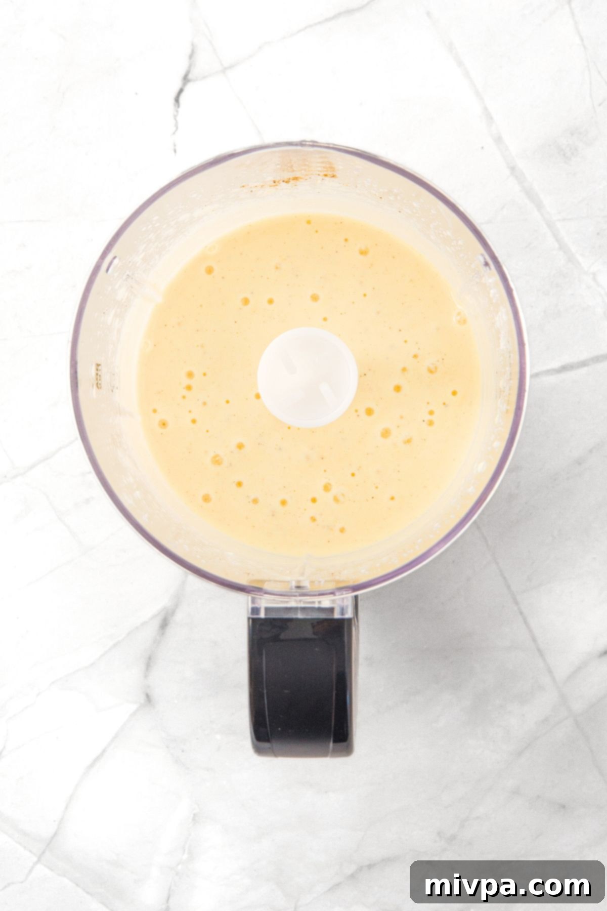 How to Make Cottage Cheese Flatbread Pale yellow liquid mixture in food processor.