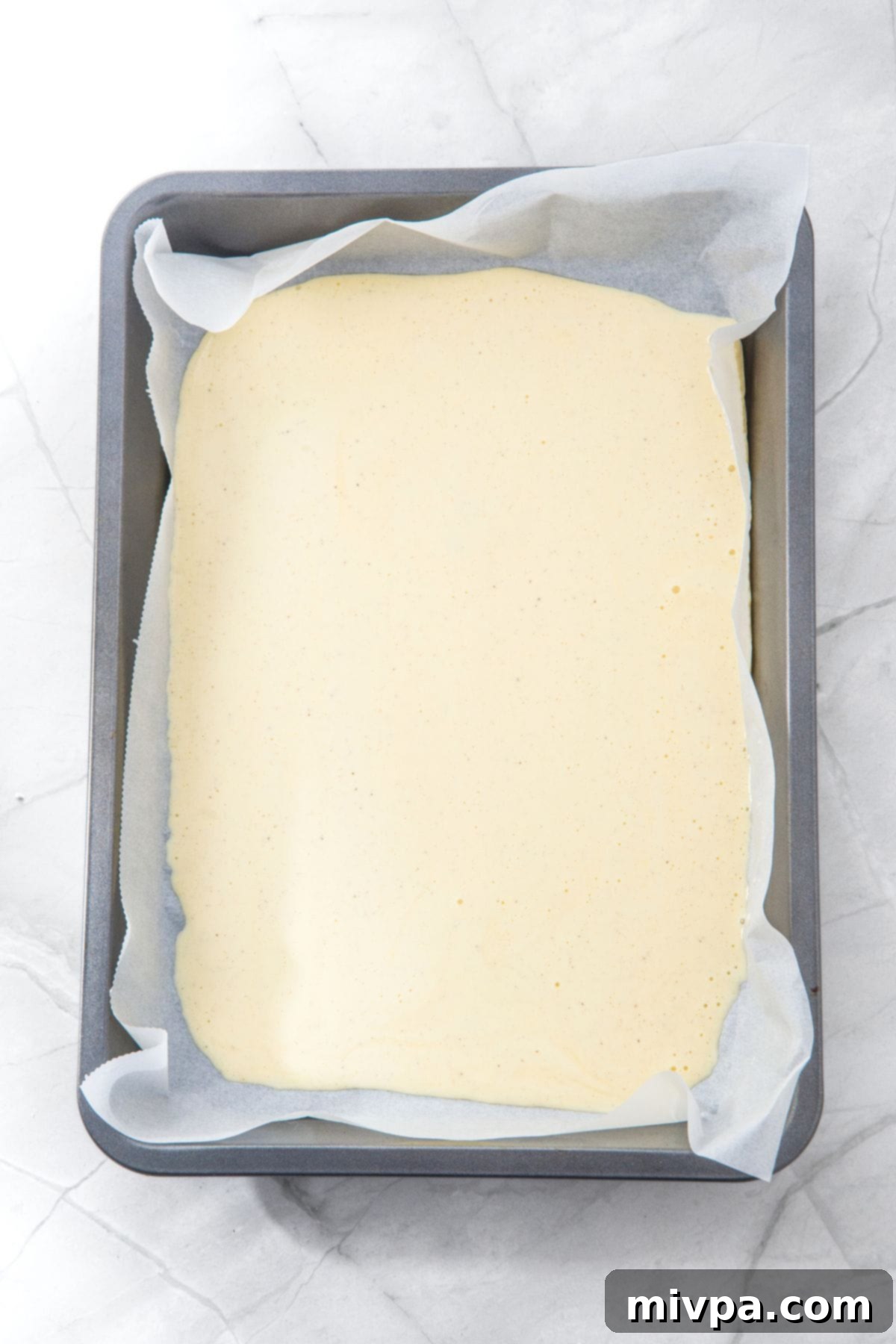 Gluten-Free Cottage Cheese Flat Bread Cottage cheese batter in parchment-lined baking sheet